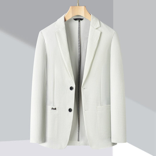 White blazer on a wooden hanger against a light gray background